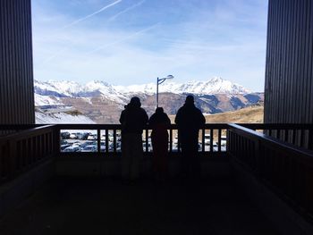 Silhouette people standing against snowcapped mountain