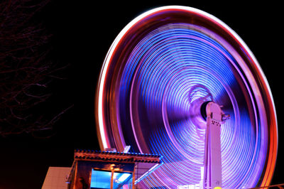 Blurred motion of ferris wheel at night