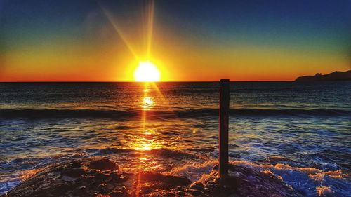 Scenic view of sea against clear sky during sunset