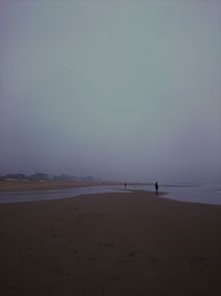 Scenic view of beach against clear sky