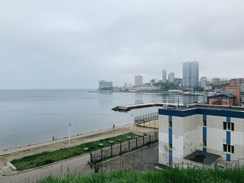 High angle view of sea and buildings against sky