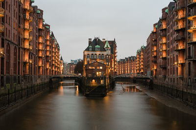 Canal amidst buildings in city