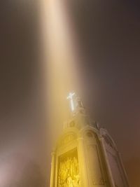 Low angle view of illuminated building against sky at night