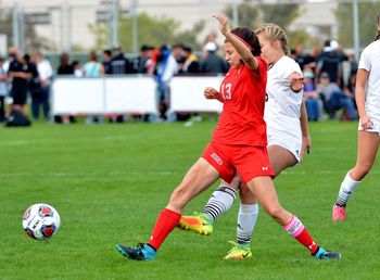 People playing soccer on field