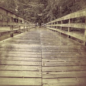 Text on footbridge against sky