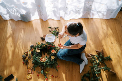 High angle view of girl playing with christmas tree