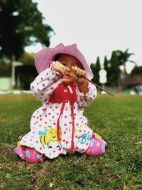 Close-up of girl with pink hat on grass