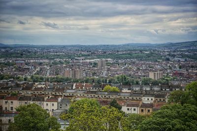View of cityscape against cloudy sky