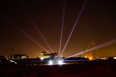 Illuminated bridge against sky at night