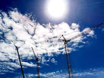 Low angle view of power lines against blue sky