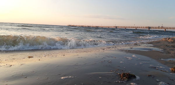 Scenic view of beach against sky during sunset