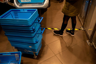 Low section of man standing on tiled floor