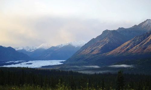 Scenic view of mountains and lake against sky