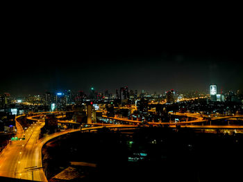 High angle view of illuminated city buildings at night