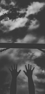 Silhouette person with hands in background