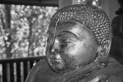 Close-up of buddha statue against temple