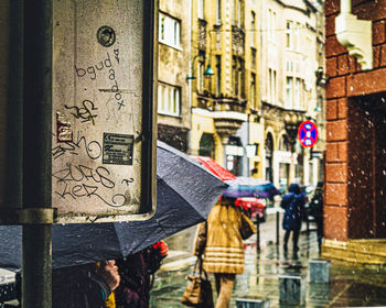 People walking on street in rain