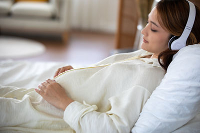 Young woman sleeping on bed