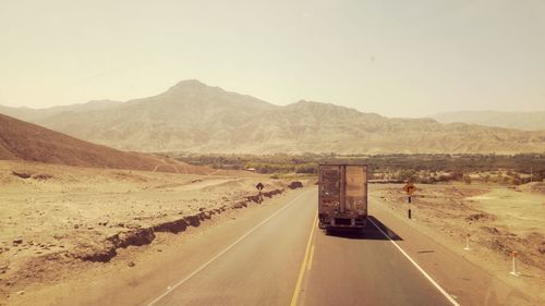 Road in desert against clear sky