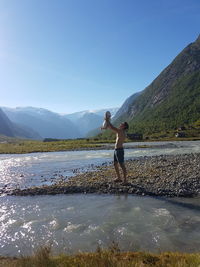 Father and child by lake and mountains beautiful