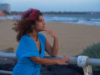 Young woman looking at sea shore