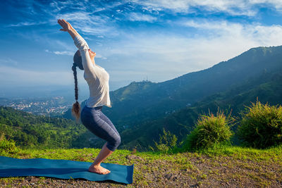 Full length of woman standing on mountain