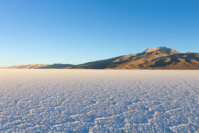 Scenic view of desert against clear sky