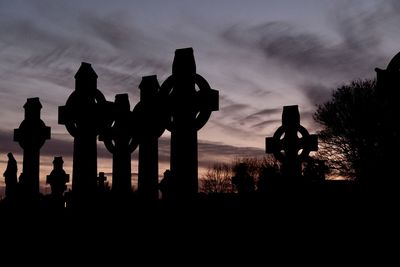 Silhouette trees against sky during sunset