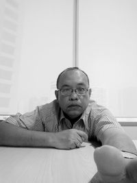 Portrait of man sitting on table