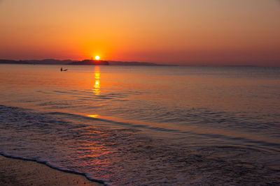 Scenic view of sea against romantic sky at sunset