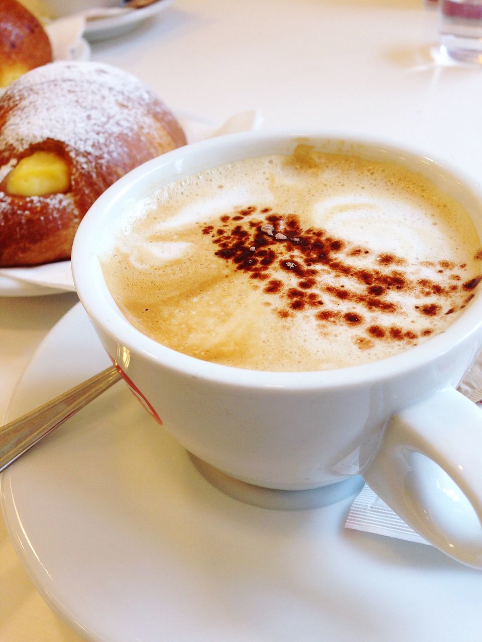 food and drink, coffee cup, drink, refreshment, indoors, freshness, coffee - drink, saucer, frothy drink, cappuccino, table, coffee, still life, close-up, cup, froth art, spoon, selective focus, high angle view, no people