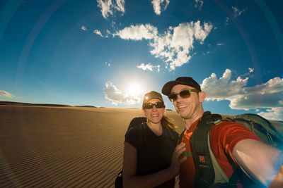 Portrait of smiling man and woman hiking in desert