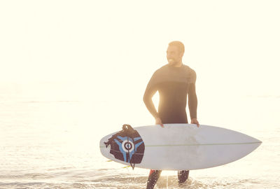 Man standing on beach against clear sky