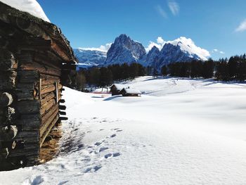 Scenic view of snow covered landscape against blue sky