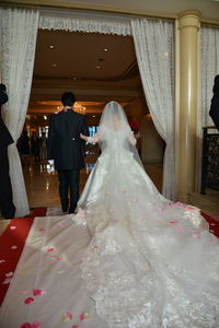 Rear view of couple standing at entrance of temple