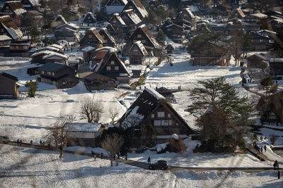 High angle view of snow covered buildings in town