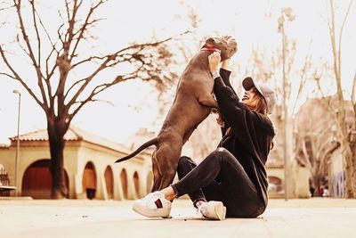 Man feeding horse against sky