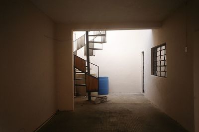 Empty corridor of building in mexico with spiral staircase 