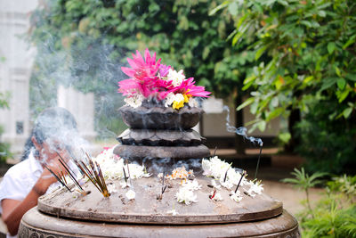 Shrine ornament. flowers from lotus plant. smoke. incense sticks.