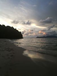 Scenic view of beach against sky during sunset