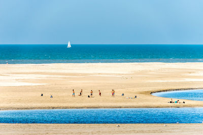 People at beach during sunny day