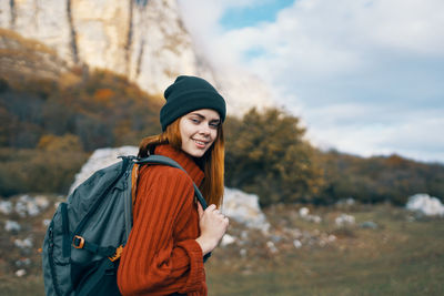 Young woman wearing hat standing outdoors