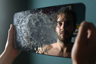 Portrait of young man holding camera