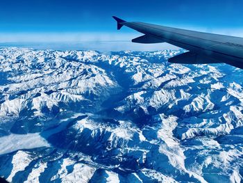 Aerial view of snowcapped mountains during winter