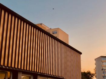 Low angle view of building against sky during sunset