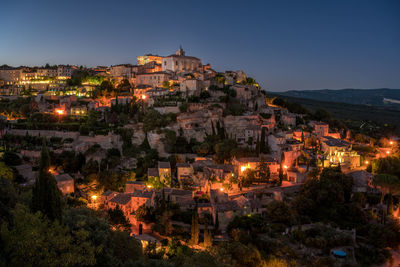 Low angle view of old town on a hill at dusk