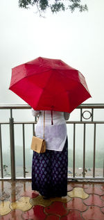 Red umbrella on wet table