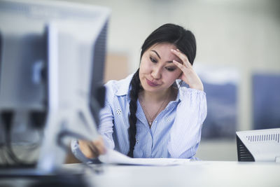 Young asia woman with paper in an office revised