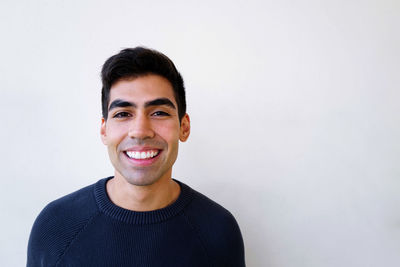 Portrait of young man against white background