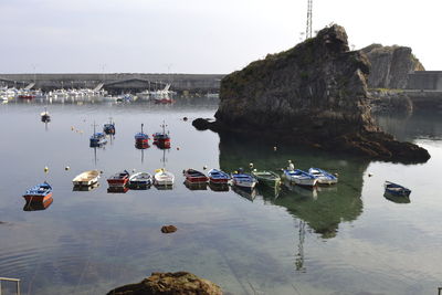 Boats moored on sea against sky